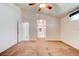 Spacious main bedroom with carpet, ceiling fan, and ensuite bathroom entrance at 2708 Turnbull Estates Dr, New Smyrna Beach, FL 32168