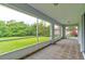 Enclosed porch with a view of the landscaped yard at 2708 Turnbull Estates Dr, New Smyrna Beach, FL 32168