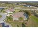 Stunning aerial view of a beautiful home with a screened pool, lush landscaping, and a well-manicured lawn at 2921 Linari Ct, New Smyrna Beach, FL 32168