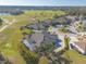 Magnificent aerial view of a home with a screened pool overlooking a beautiful golf course and a tranquil pond at 2921 Linari Ct, New Smyrna Beach, FL 32168