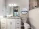 Bright bathroom with tile accents, granite countertop and white cabinetry at 2921 Linari Ct, New Smyrna Beach, FL 32168