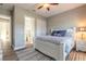 Bright bedroom featuring a white bed frame, neutral walls and an attached bathroom at 2921 Linari Ct, New Smyrna Beach, FL 32168