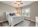 Bright bedroom featuring a white bed frame, neutral walls and a ceiling fan at 2921 Linari Ct, New Smyrna Beach, FL 32168