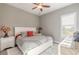 Bright bedroom featuring a white bed frame, neutral walls and large window at 2921 Linari Ct, New Smyrna Beach, FL 32168