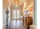 Welcoming foyer featuring decorative front doors, a stylish light fixture, and a wood accent table at 2921 Linari Ct, New Smyrna Beach, FL 32168