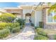 Inviting front entrance featuring a stone pathway, lush landscaping, and a covered entryway with double doors at 2921 Linari Ct, New Smyrna Beach, FL 32168