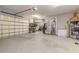 Spacious two-car garage with epoxy flooring, storage shelving, and access to both the house and outdoors at 2921 Linari Ct, New Smyrna Beach, FL 32168