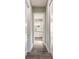 Hallway leads to a bright bathroom with double vanities, white cabinets, and modern fixtures at 2921 Linari Ct, New Smyrna Beach, FL 32168