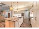 Spacious kitchen featuring a center island with seating, stainless steel appliances, and wood-look flooring at 2921 Linari Ct, New Smyrna Beach, FL 32168