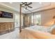 This main bedroom features wood floors, a tray ceiling, ceiling fan, and a sliding glass door to a deck at 2921 Linari Ct, New Smyrna Beach, FL 32168