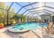 Gorgeous screened-in pool area with waterfall features and a built-in table, perfect for entertaining at 2921 Linari Ct, New Smyrna Beach, FL 32168