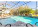 Beautiful screened-in pool area with bamboo backdrop and outdoor furniture for relaxing at 2921 Linari Ct, New Smyrna Beach, FL 32168