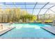 Sparkling pool with stone water features surrounded by screened enclosure at 2921 Linari Ct, New Smyrna Beach, FL 32168