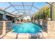 Captivating screened-in pool with stone accents, a water feature, and comfortable seating at 2921 Linari Ct, New Smyrna Beach, FL 32168