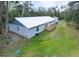 Back exterior of home featuring a deck and metal roof at 2995 Ragis Rd, Edgewater, FL 32132