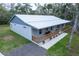 Single story home featuring a metal roof, a front porch and a well manicured front yard at 2995 Ragis Rd, Edgewater, FL 32132