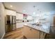 Kitchen featuring stainless steel appliances, white cabinets, and a spacious island with marble counter at 2995 Ragis Rd, Edgewater, FL 32132