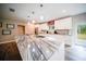 Kitchen featuring a waterfall island countertop, modern appliances, and a view to the deck at 2995 Ragis Rd, Edgewater, FL 32132