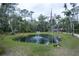 Aerial view of a pond with fountain and an American flag at 2995 Ragis Rd, Edgewater, FL 32132