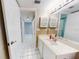 Bathroom featuring a tiled floor, large mirror, and vanity sink at 3 Oceans West Boulevard # 3B1, Daytona Beach Shores, FL 32118