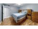 Cozy bedroom featuring wood floors, a ceiling fan, and wooden furniture at 3 Oceans West Boulevard # 3B, Daytona Beach Shores, FL 32118