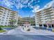 Inviting condo complex with well-maintained landscaping, covered parking, and a charming guard house at 3 Oceans West Boulevard # 3B1, Daytona Beach Shores, FL 32118