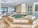 Indoor hot tub with tile steps and a view to the pool at 3 Oceans West Boulevard # 3B1, Daytona Beach Shores, FL 32118