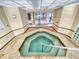 Indoor hot tub surrounded by neutral-toned tile and glass block at 3 Oceans West Boulevard # 3B, Daytona Beach Shores, FL 32118