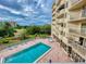 Aerial view of a pristine pool and community landscaping at 3 Oceans West Boulevard # 3B, Daytona Beach Shores, FL 32118