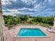 Aerial view of a pool with a landscaped exterior and clear blue skies at 3 Oceans West Boulevard # 3B, Daytona Beach Shores, FL 32118