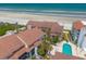 Aerial shot of luxury villa resort on beach front with tile roofs at 3001 S Atlantic Ave # 204, New Smyrna Beach, FL 32169