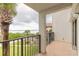 Relaxing balcony view featuring a palm tree, ocean, and vibrant green landscape at 3001 S Atlantic Ave # 204, New Smyrna Beach, FL 32169