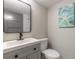 This bathroom has a modern sink and fixtures, coastal artwork and a large vanity for storage at 3001 S Atlantic Ave # 204, New Smyrna Beach, FL 32169