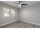 Bedroom featuring wood-look floors, shuttered windows and a modern ceiling fan with overhead lighting at 3001 S Atlantic Ave # 204, New Smyrna Beach, FL 32169