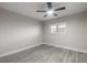 Neutral bedroom with modern ceiling fan and gray wood floors at 3001 S Atlantic Ave # 204, New Smyrna Beach, FL 32169