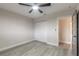 Bedroom featuring modern ceiling fan, spacious closet and grey wood-look flooring at 3001 S Atlantic Ave # 204, New Smyrna Beach, FL 32169