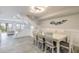 Bright dining room with a modern light fixture and a staircase leading to another level at 3001 S Atlantic Ave # 204, New Smyrna Beach, FL 32169