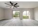 Bright living room with beach view from balcony and large arched window at 3001 S Atlantic Ave # 204, New Smyrna Beach, FL 32169