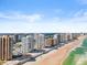 Elevated aerial view of beachfront condos, beach access, and blue ocean and intracoastal waterway views at 3047 S Atlantic Ave # B050, Daytona Beach, FL 32118