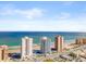 Wide aerial view of multiple beachfront condo buildings showcasing beach access and blue ocean views at 3047 S Atlantic Ave # B050, Daytona Beach, FL 32118