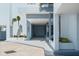 Condo complex entrance with a covered entryway, palm trees, and a blue and white exterior at 3047 S Atlantic Ave # B050, Daytona Beach, FL 32118