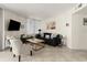 Well-lit living room with modern furniture, tile floors, and neutral paint at 3047 S Atlantic Ave # B050, Daytona Beach, FL 32118