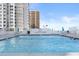 Outdoor pool with blue water and lounge chairs offers a relaxing amenity for residents at 3047 S Atlantic Ave # B050, Daytona Beach, FL 32118