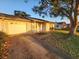 Home exterior featuring a one car garage and a mature shade tree at 309 Sea Hawk Ct, Edgewater, FL 32141