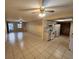 Open-concept living room and kitchen area with tile floors and ceiling fans at 309 Sea Hawk Ct, Edgewater, FL 32141