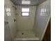 Tiled shower featuring built-in showerhead and grab bar for safety at 311 Sea Hawk Ct, Edgewater, FL 32141