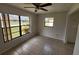 Bright bedroom features large windows offering great natural light and neutral tile flooring at 311 Sea Hawk Ct, Edgewater, FL 32141