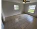 Bright main bedroom with tiled floor, a ceiling fan, and natural light from windows at 311 Sea Hawk Ct, Edgewater, FL 32141