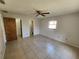 Tiled main bedroom with ceiling fan, closet, and access to ensuite bathroom at 311 Sea Hawk Ct, Edgewater, FL 32141