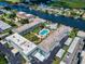 Aerial view of the condo complex showcasing a pool, shuffleboard court, and canal access at 315 N Causeway # 405, New Smyrna Beach, FL 32169